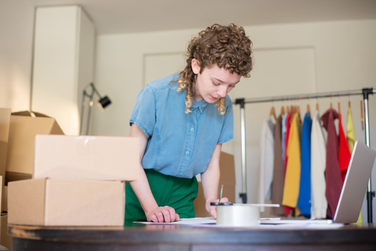 Order being packed next to a clothing rack